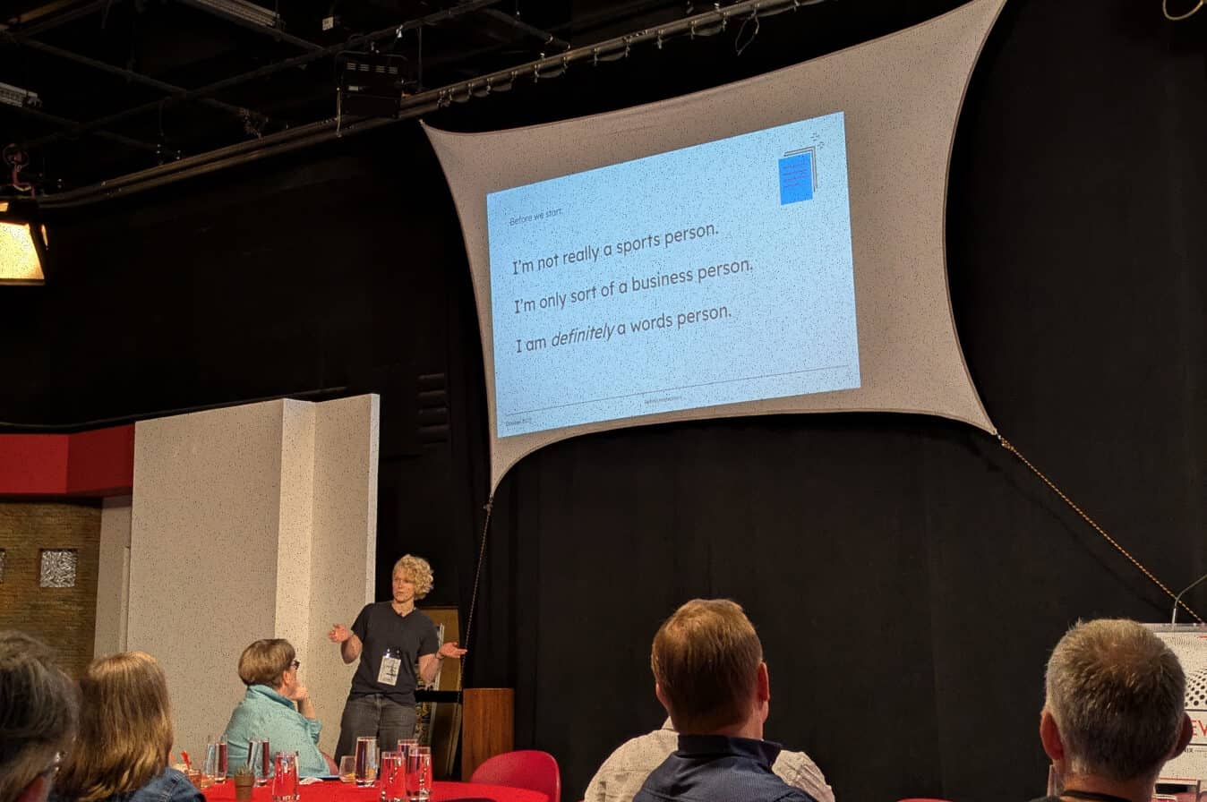 Speaker giving a talk at Newsgeist 2025.